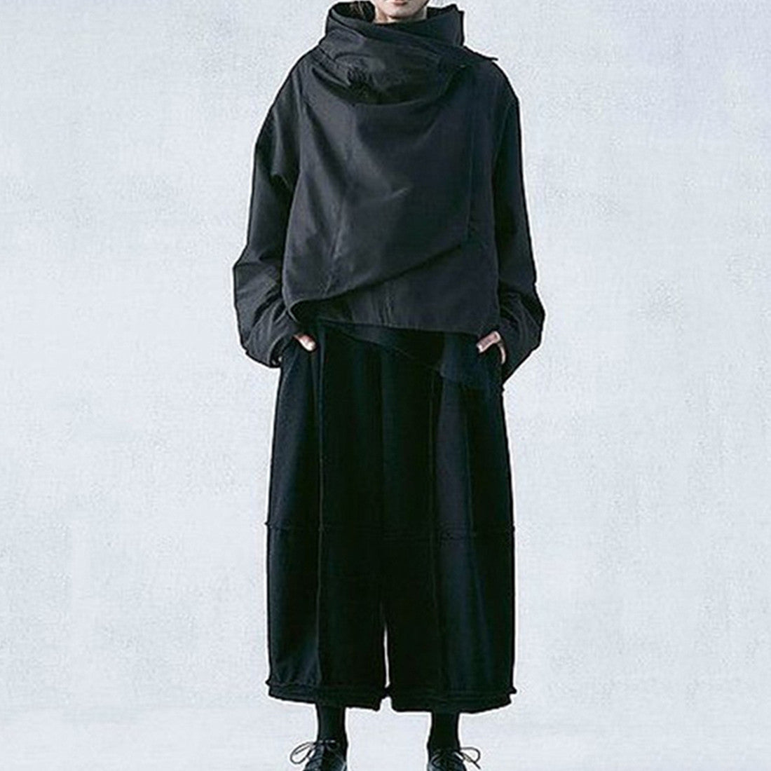 Dark avant-garde jacket with wrap collar styled over hakama pants – full look