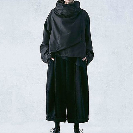 Dark avant-garde jacket with wrap collar styled over hakama pants – full look