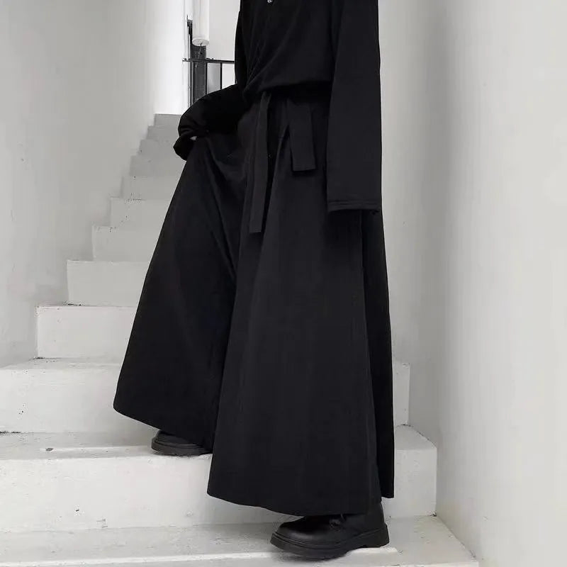 Dark avant-garde hakama trousers in polyester – movement shot on stairs