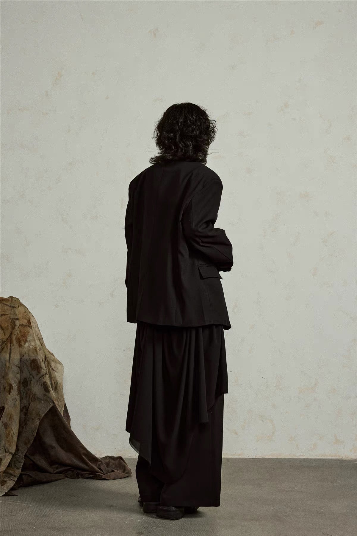 Back close-up of the black blazer showing the relaxed shoulder line