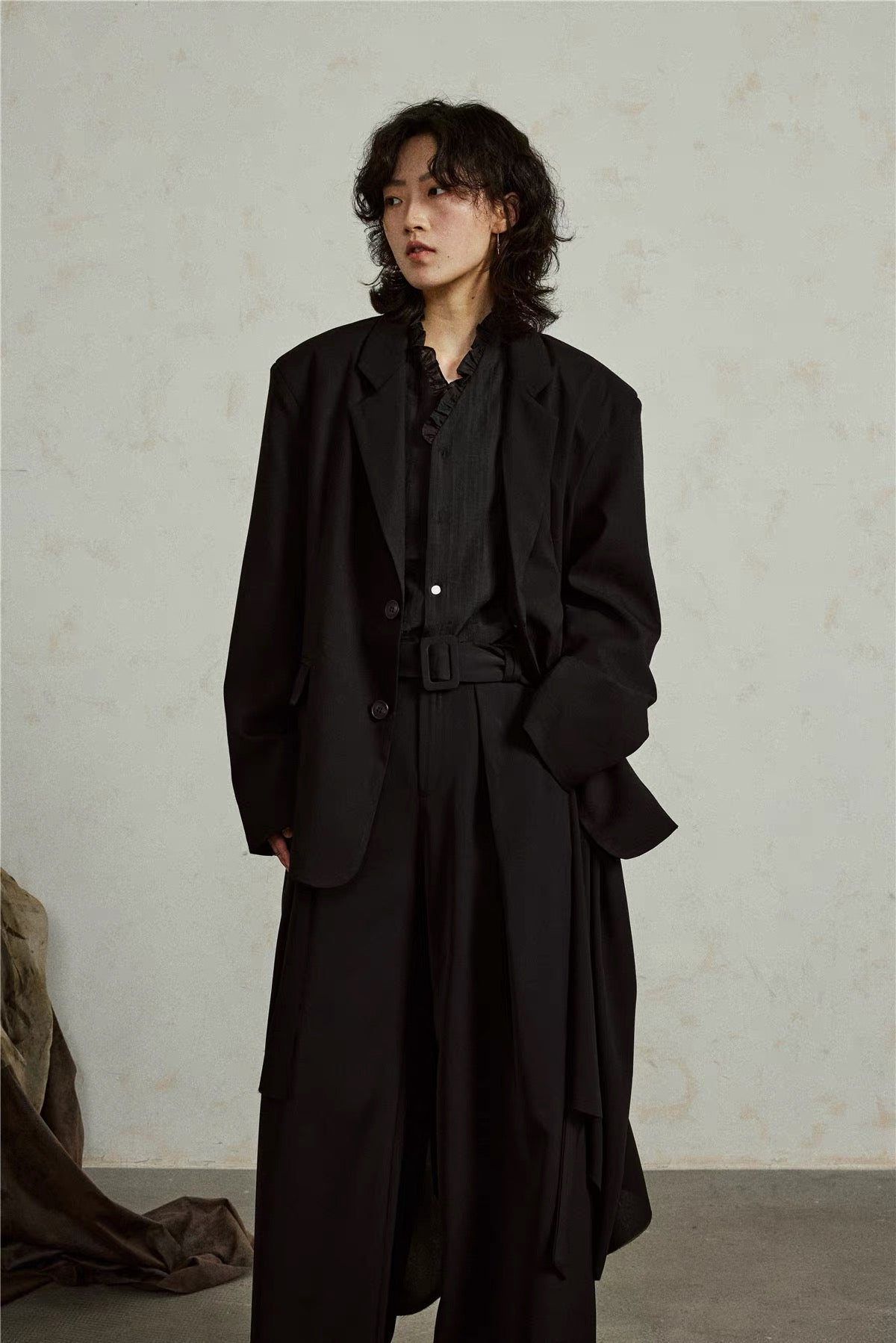 Detachable Draped Hem Blazer in black, three-quarter front view with the long asymmetric panel