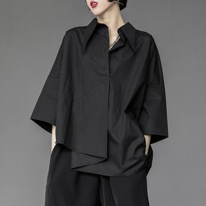 Dark avant-garde fashion shirt – irregular hem detail – front close view