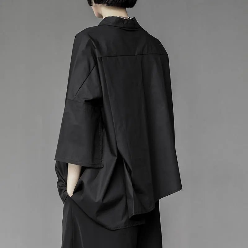 Oversized dark avant-garde shirt – back view – wide sleeve detail