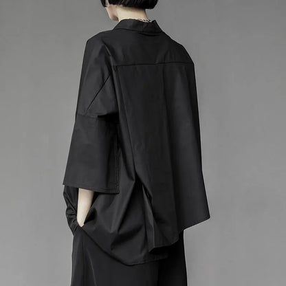 Oversized dark avant-garde shirt – back view – wide sleeve detail